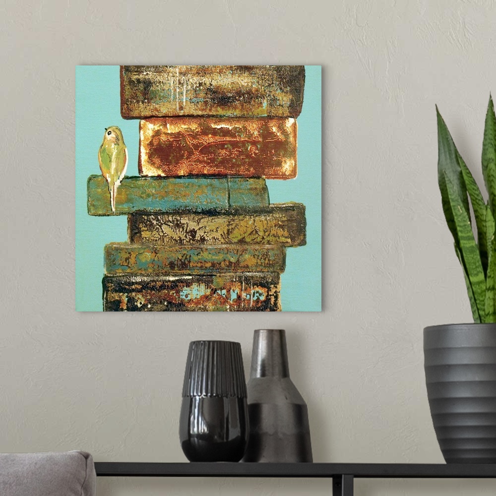 A modern room featuring A small bird perched on the edge of a stack of weathered books.