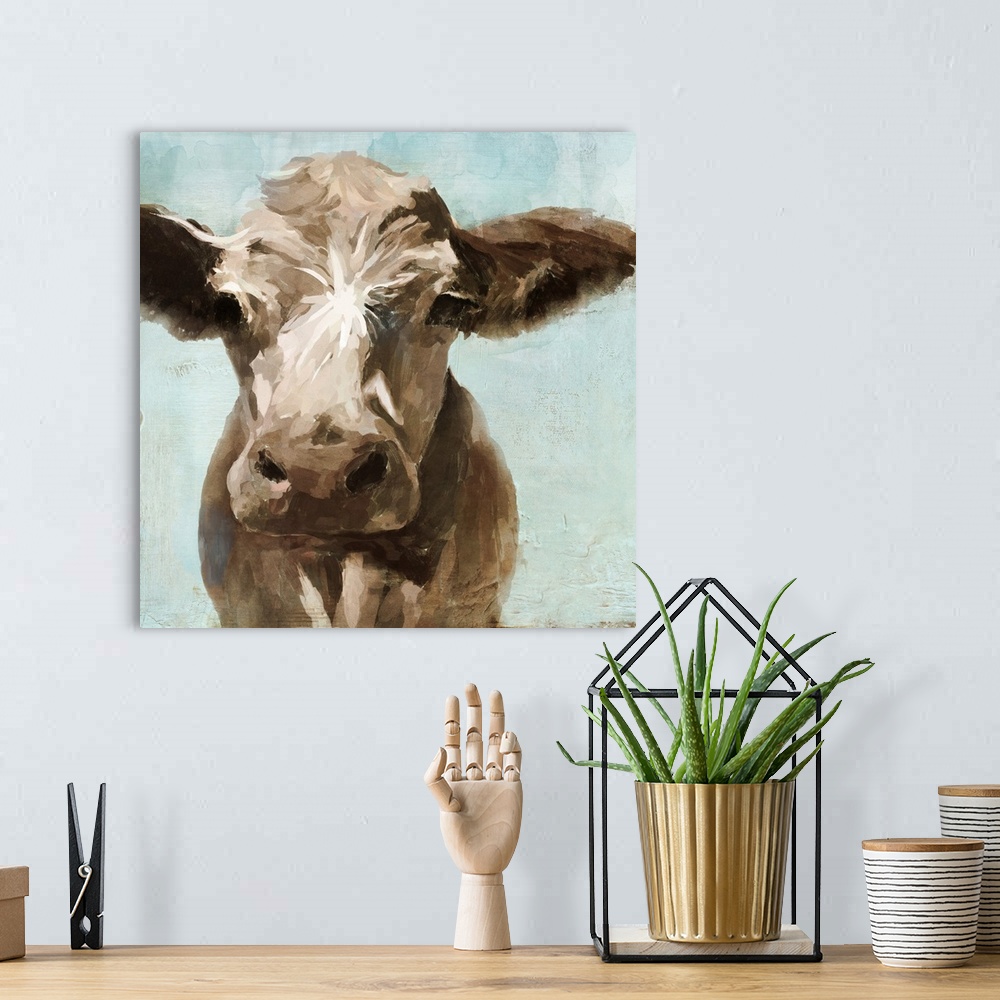 A bohemian room featuring A contemporary painting of a brown cow on a pale blue background.