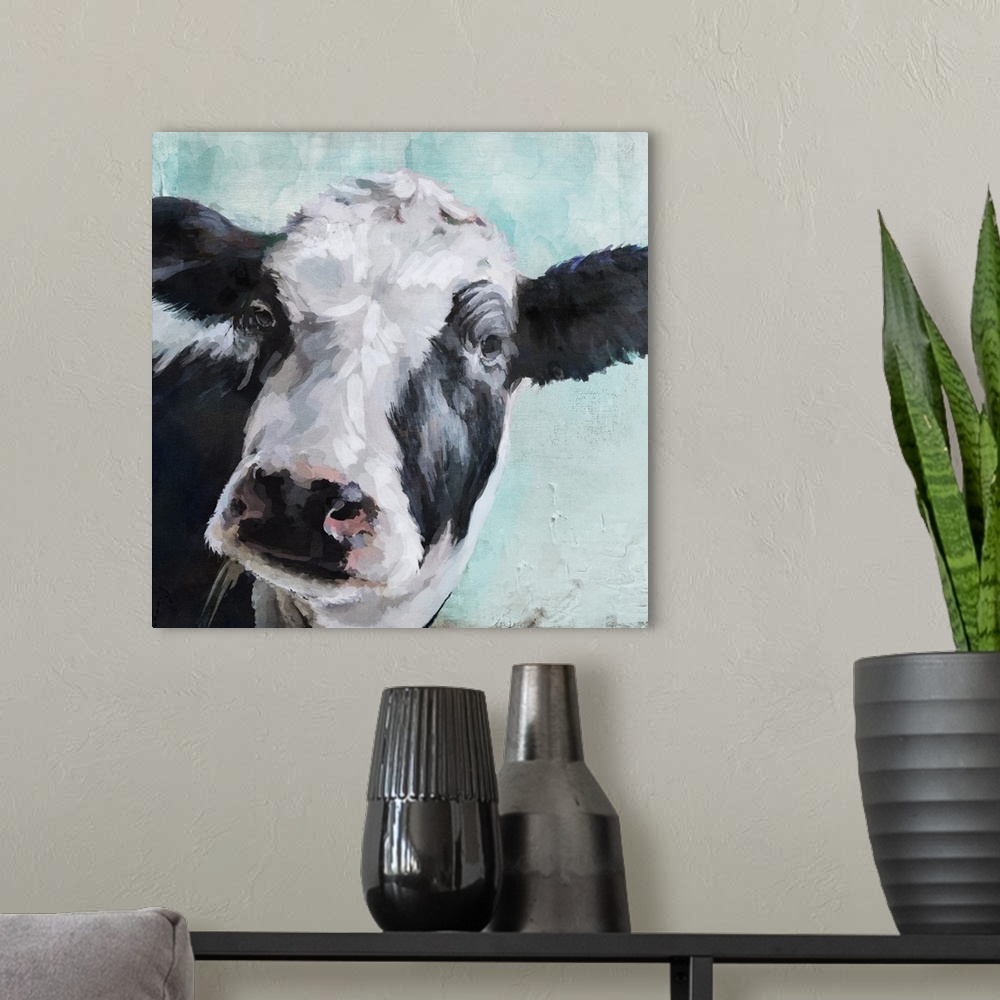 A modern room featuring A contemporary painting of a black and white cow on a pale blue background.