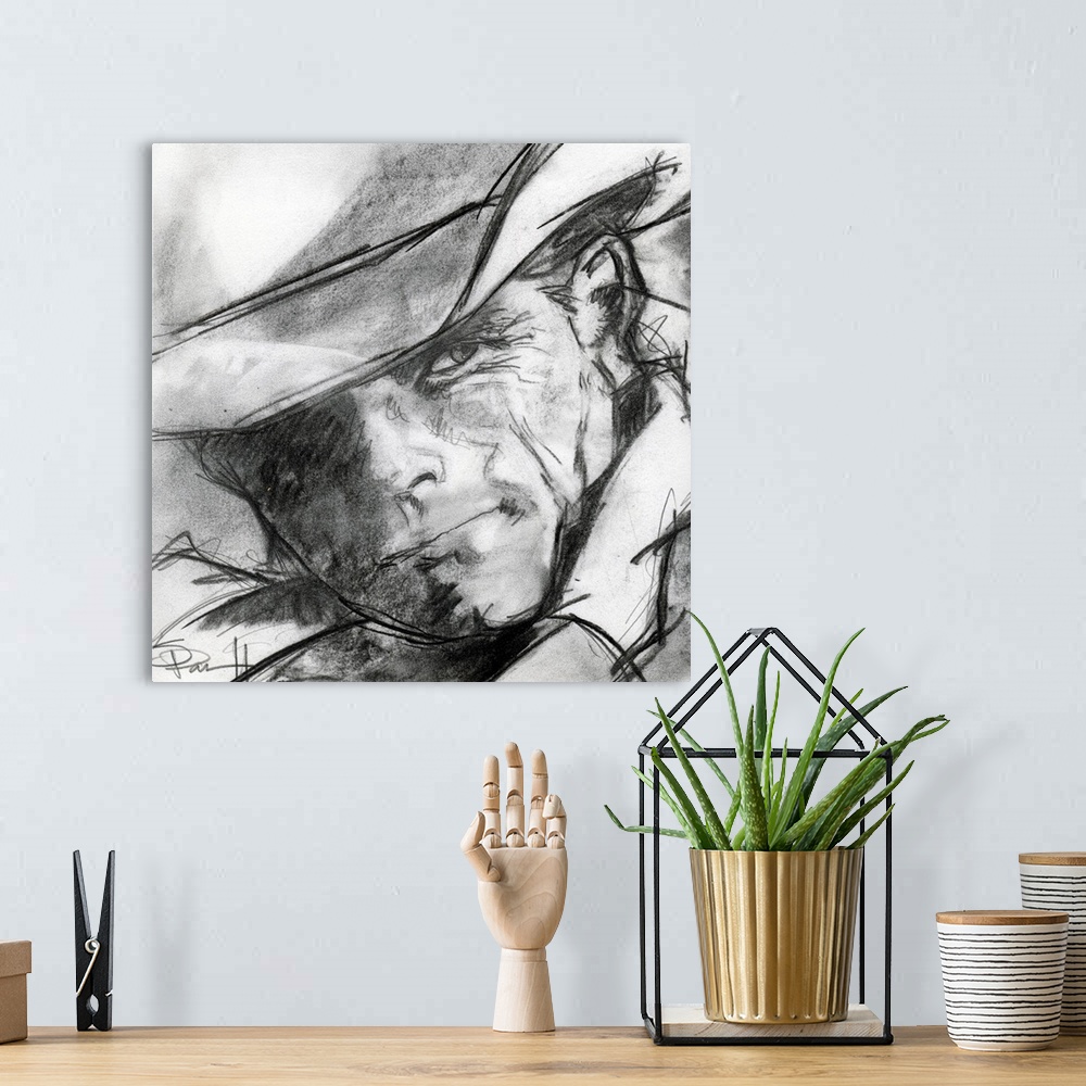 A bohemian room featuring Black and white sketch of a cowboy's face.