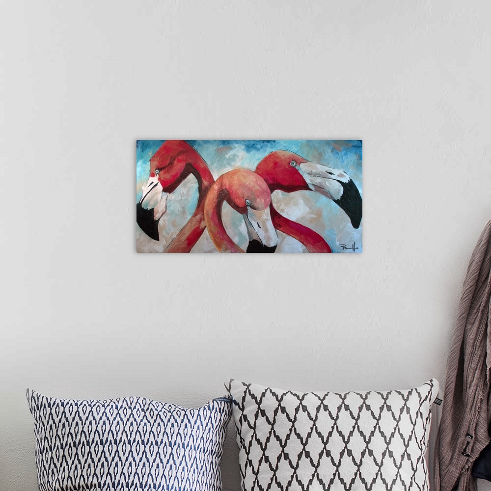 A bohemian room featuring Painting of three pink flamingos.