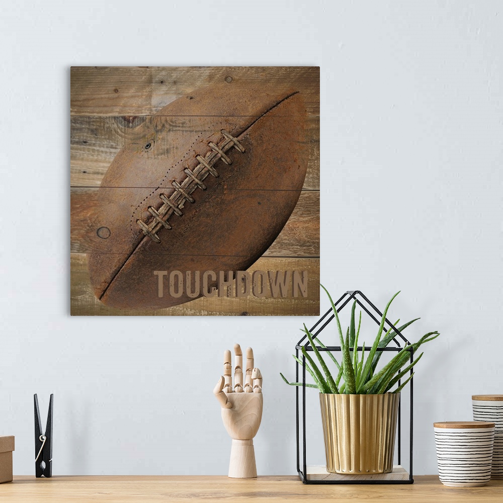 A bohemian room featuring Image of a football with the word "Touchdown" on a wooden background.
