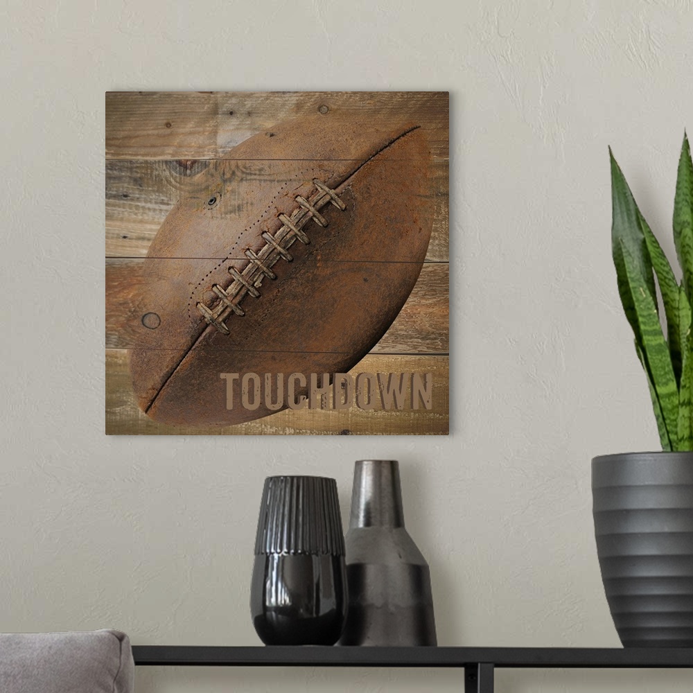 A modern room featuring Image of a football with the word "Touchdown" on a wooden background.