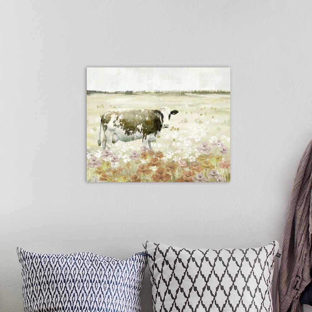 A bohemian room featuring Decorative artwork of a black and white cow in a field full of flowers.