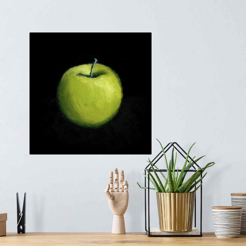 A bohemian room featuring Contemporary still-life painting of a green apple against a black a background.