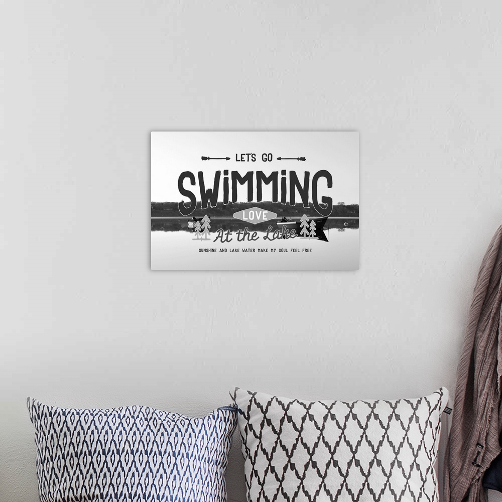 A bohemian room featuring Typography artwork reading "Let's go swimming, love at the lake," over a black and white image of...