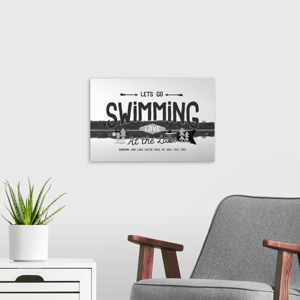 A modern room featuring Typography artwork reading "Let's go swimming, love at the lake," over a black and white image of...