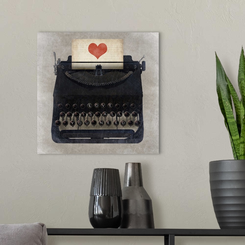 A modern room featuring A vintage typewriter with "Love is all you need" on the keys and a heart on the paper.