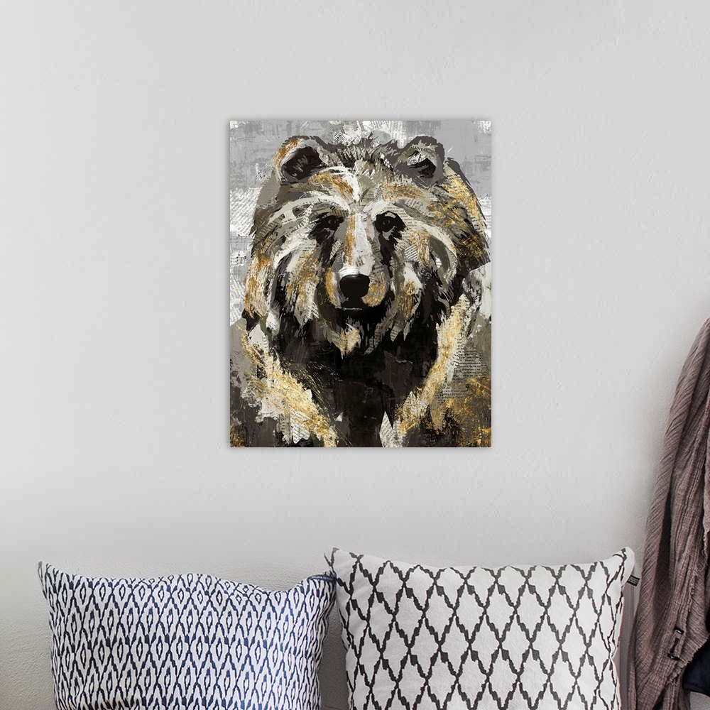 A bohemian room featuring A decorative image of a bear with gold accents on a gray backdrop with faded newspaper peeping th...