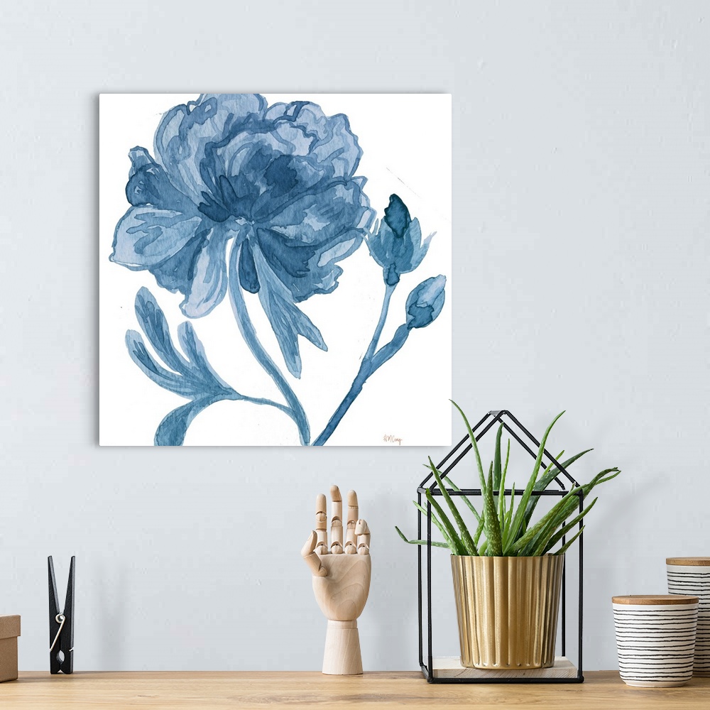 A bohemian room featuring A blooming flower and two small buds in blue tones.