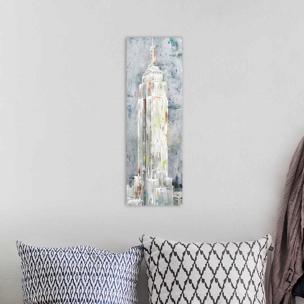 A bohemian room featuring A long vertical painting of the Empire State building in New York, done in textured muted tones.