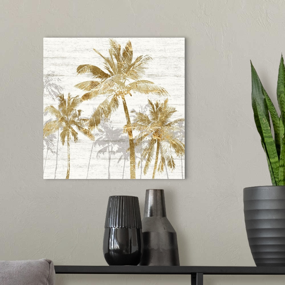 A modern room featuring Square artwork of a group of gold palm trees with gray trees behind, on a white wood backdrop.