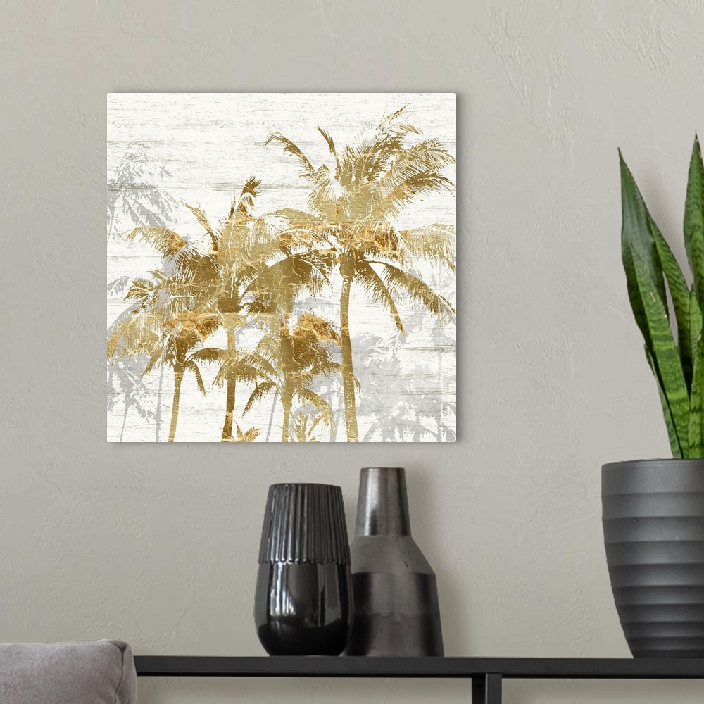 A modern room featuring Square artwork of a group of gold palm trees with gray trees behind, on a white wood backdrop.