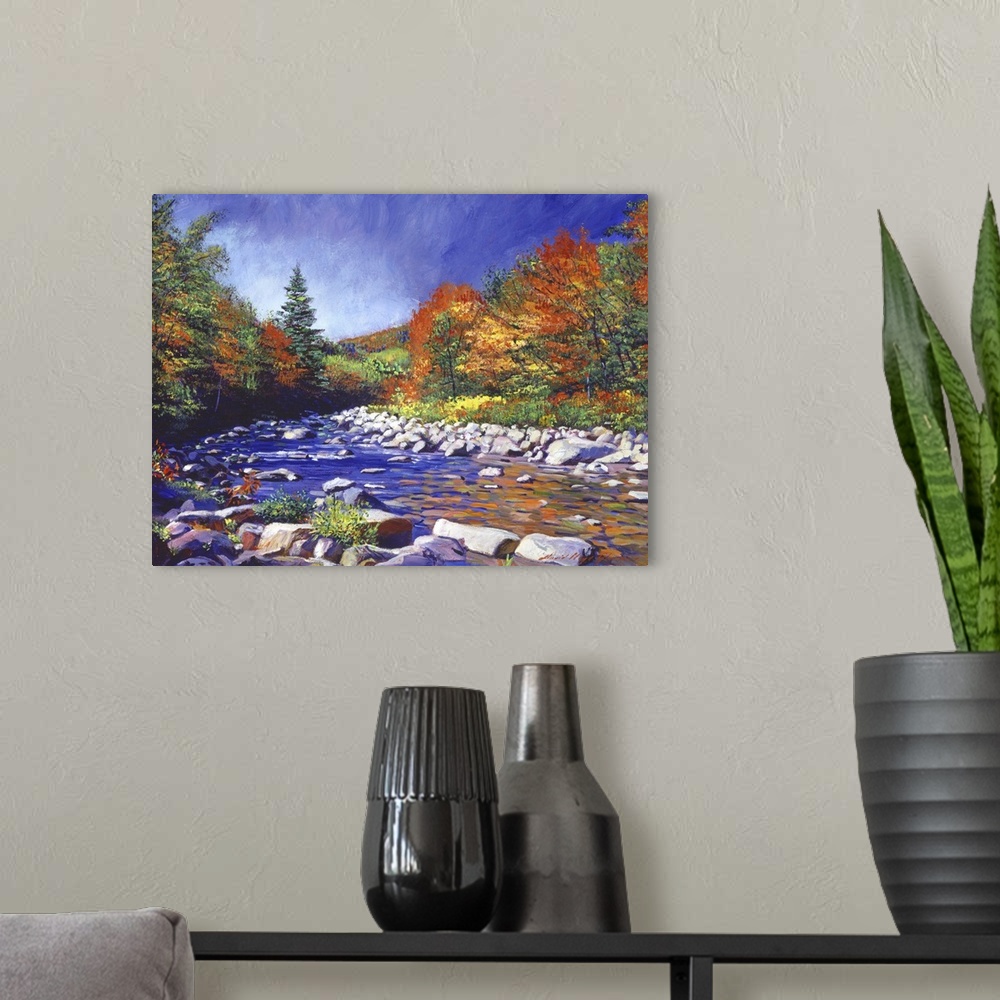 A modern room featuring Painting of a river lined with rocks and trees turning fall colors.