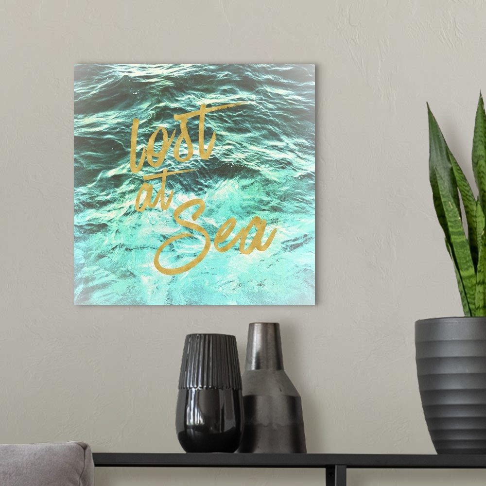A modern room featuring "Lost at Sea" in golden script over an image of rippling ocean waves.