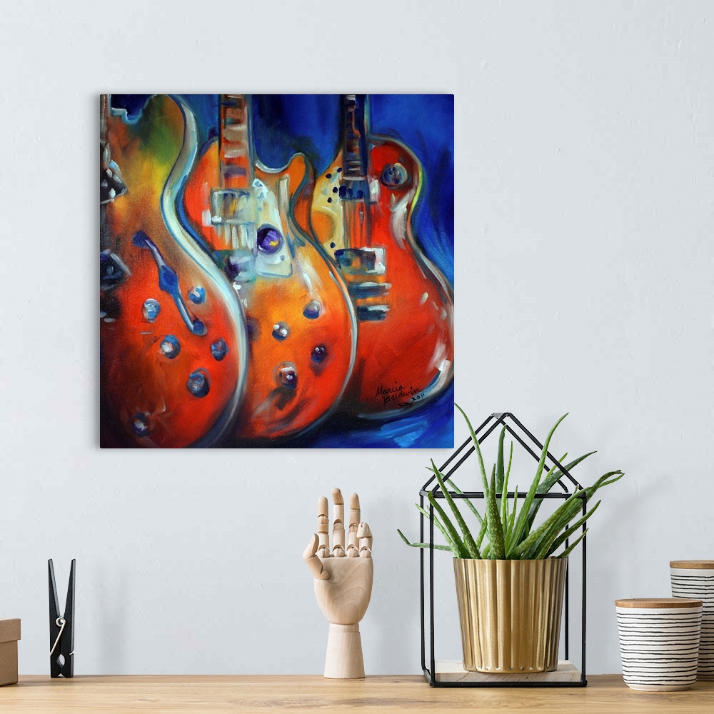 A bohemian room featuring Square painting in red, blue, yellow, orange, and green hues of three guitars standing up in a row.