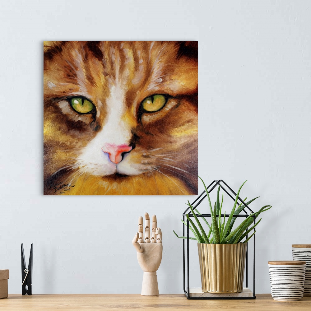 A bohemian room featuring Close-up painting of a brown and yellow striped kitten's face with green and yellow eyes on a squ...