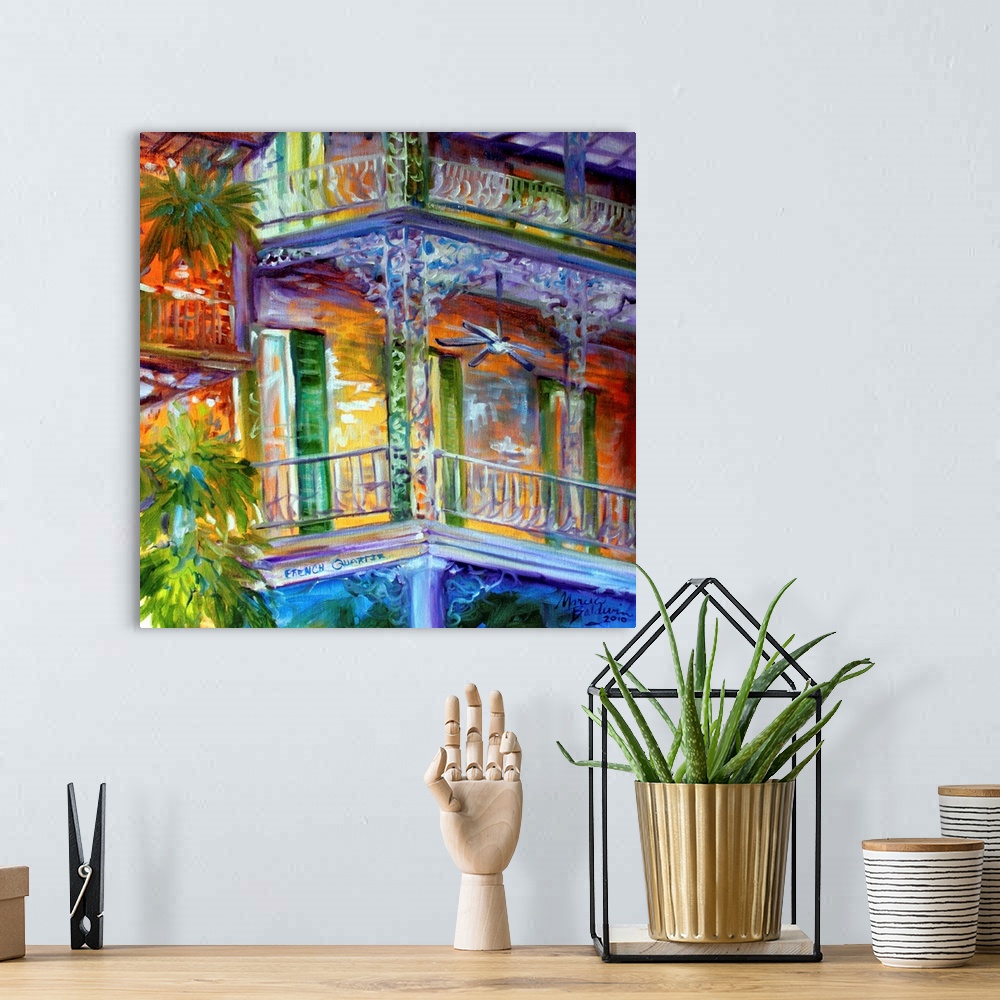 A bohemian room featuring Contemporary square painting depicting a scene in the French Quarters of New Orleans.