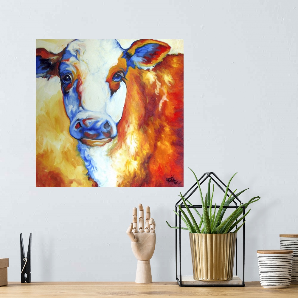 A bohemian room featuring Contemporary painting of a cow made with orange, yellow, red, white, and blue hues on a square ba...