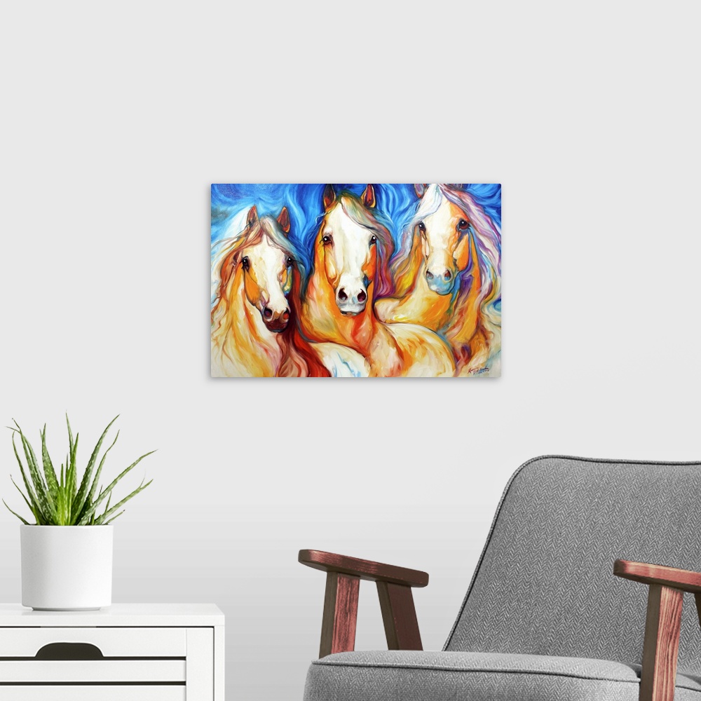 A modern room featuring Contemporary painting of three light brown horses with flowing manes on a blue background.