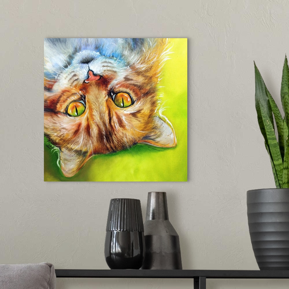 A modern room featuring Square painting of an orange striped cat laying upside down on a bright green and yellow background.
