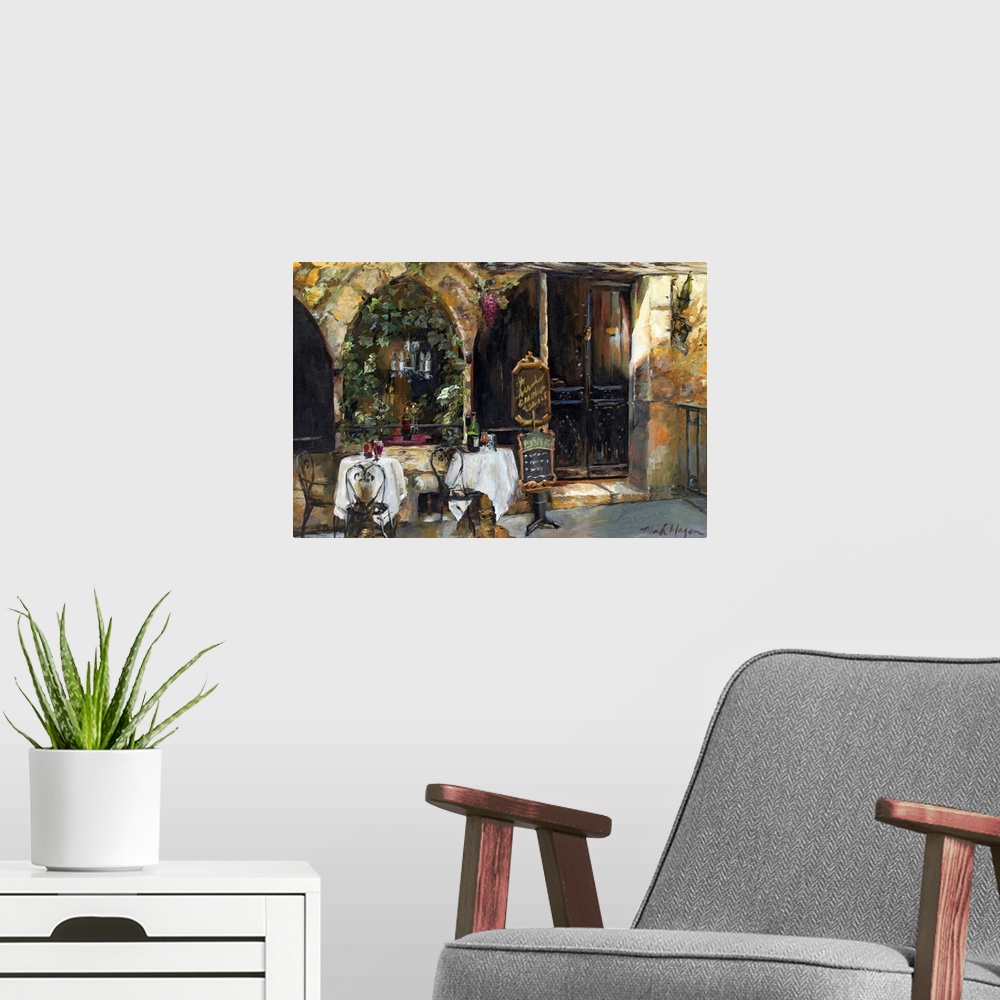 A modern room featuring An impressionistic painting of an outdoor cafo in a rustic European city.