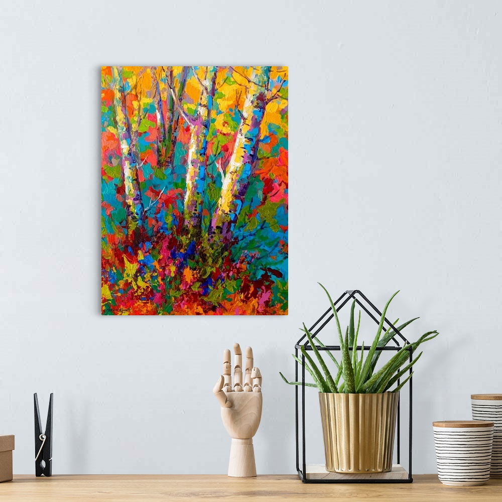A bohemian room featuring Large contemporary art depicts the bases of a few bare trees surrounded by a vibrantly colored ba...