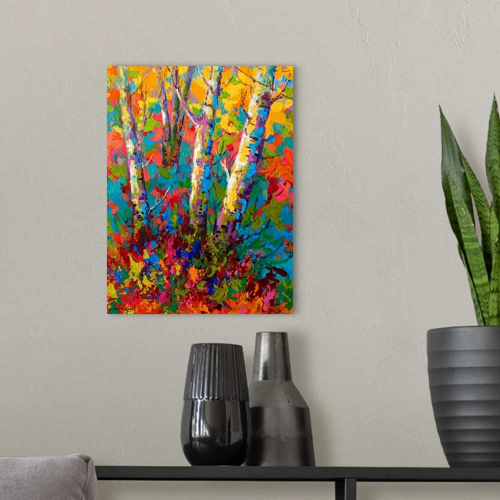 A modern room featuring Large contemporary art depicts the bases of a few bare trees surrounded by a vibrantly colored ba...