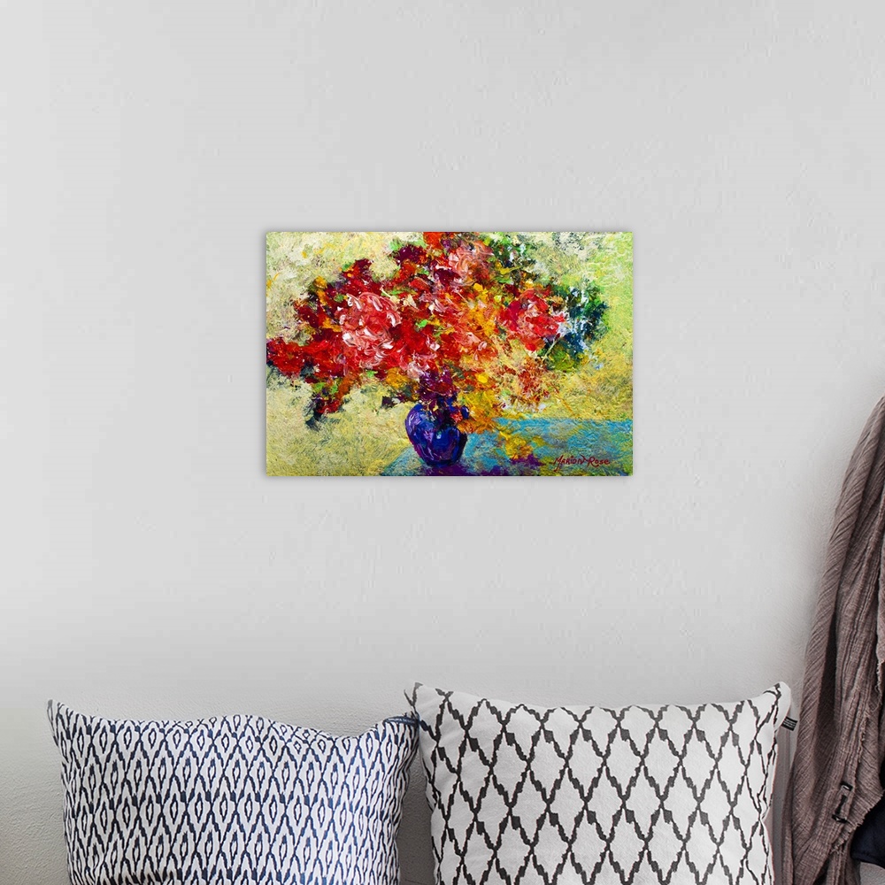 A bohemian room featuring Textured painting of flower filled vase on table.