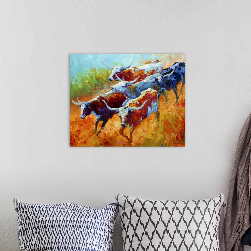 A bohemian room featuring Big landscape painting of a small group of longhorn cattle running down a grassy hill.   Painted ...