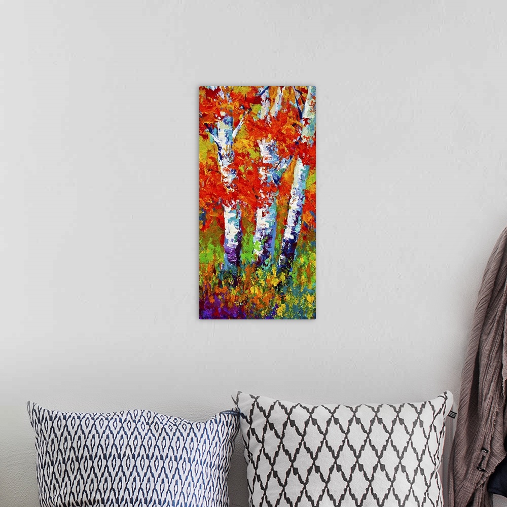 A bohemian room featuring Vertical painting on a big canvas of several birch trees surrounded by vibrant fall leaves and gr...
