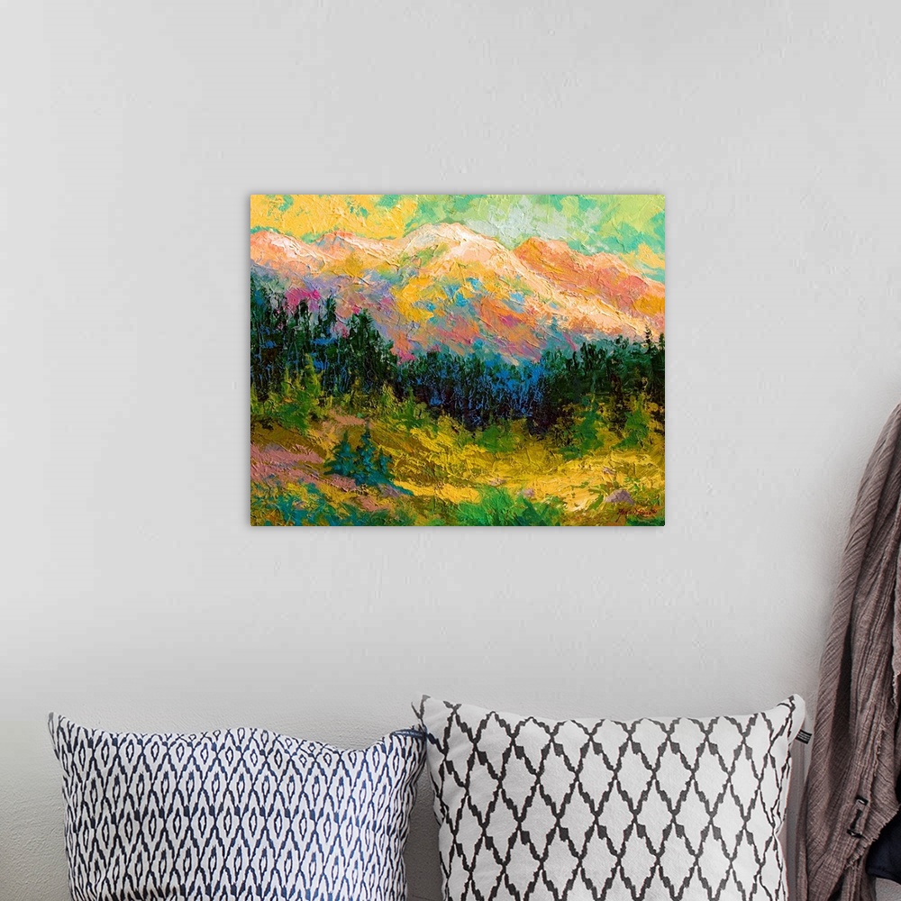 A bohemian room featuring Contemporary artwork that is a painting of a mountain scape with pine trees lining the bottom of ...