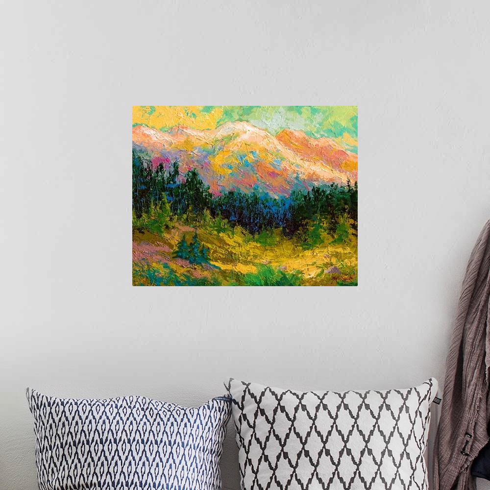 A bohemian room featuring Contemporary artwork that is a painting of a mountain scape with pine trees lining the bottom of ...