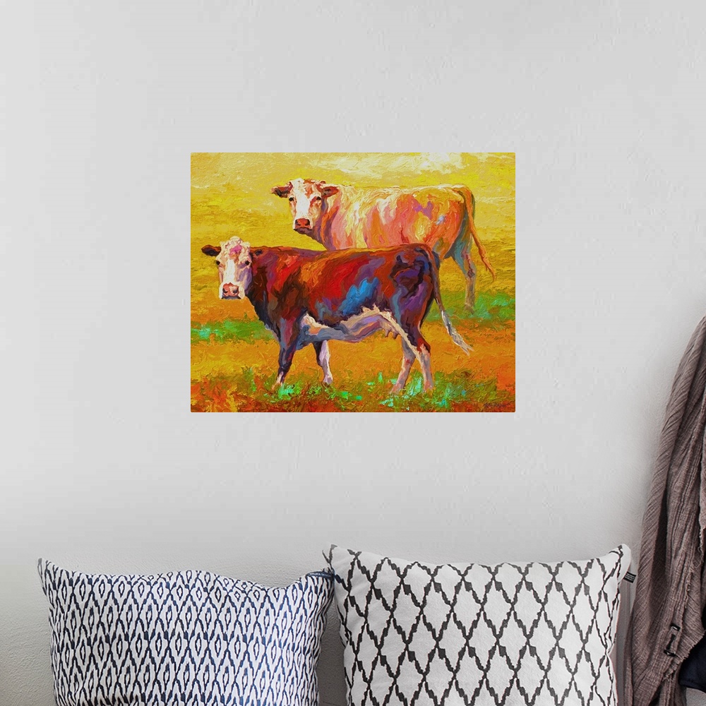 A bohemian room featuring A pair of cows looking forward on a brightly-painted landscape.