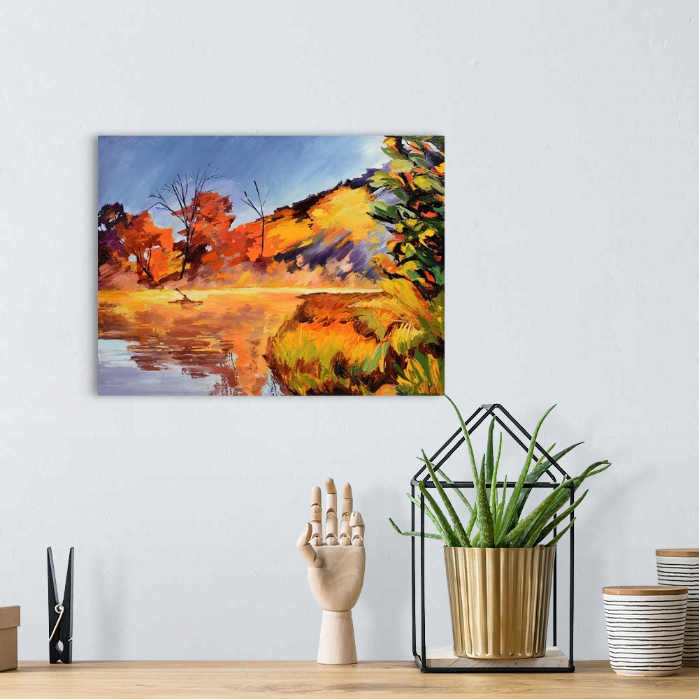 A bohemian room featuring Kayaker on lake with trees and mountain in background.