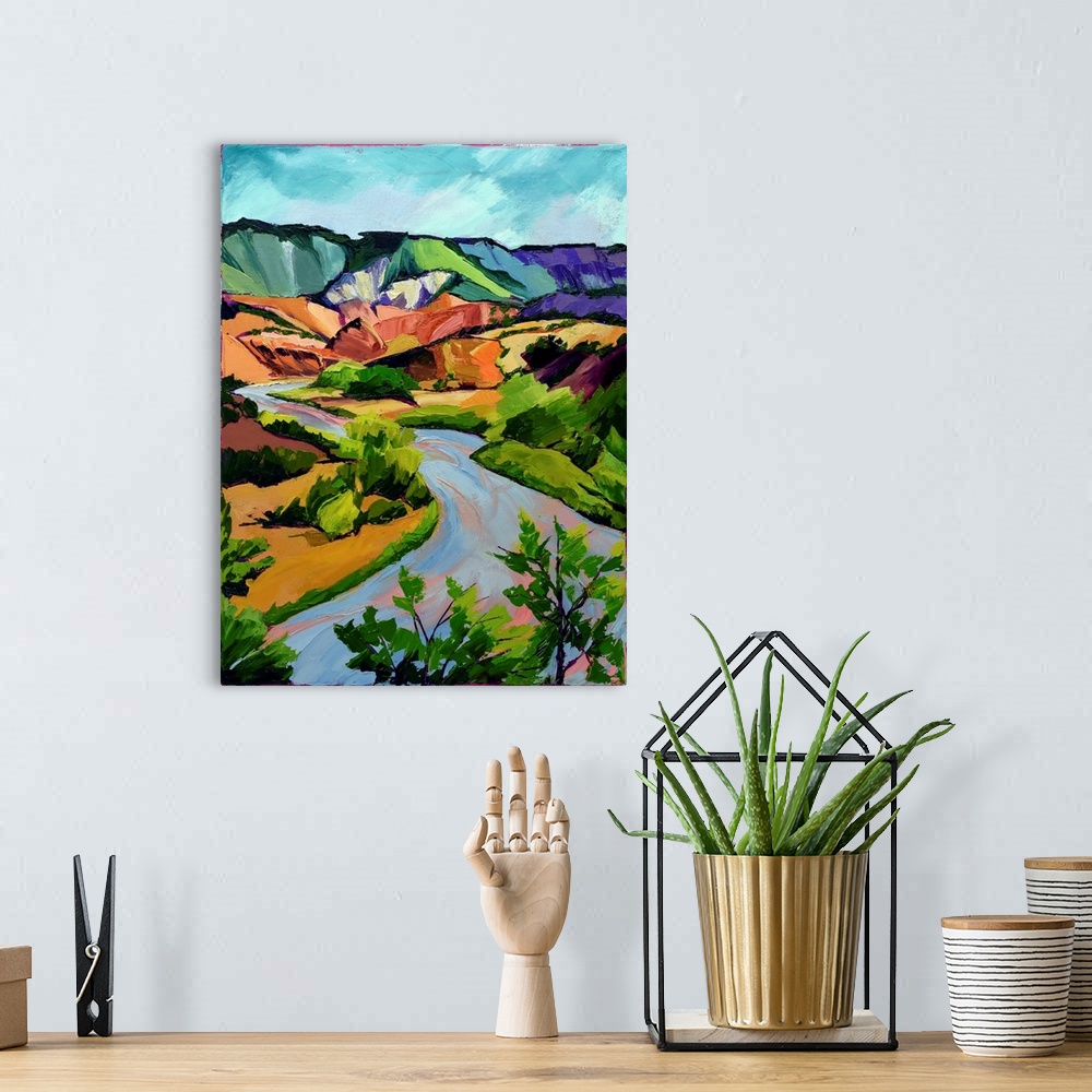 A bohemian room featuring Scene in New Mexico of mountains, river, and valley in vivid colors.
