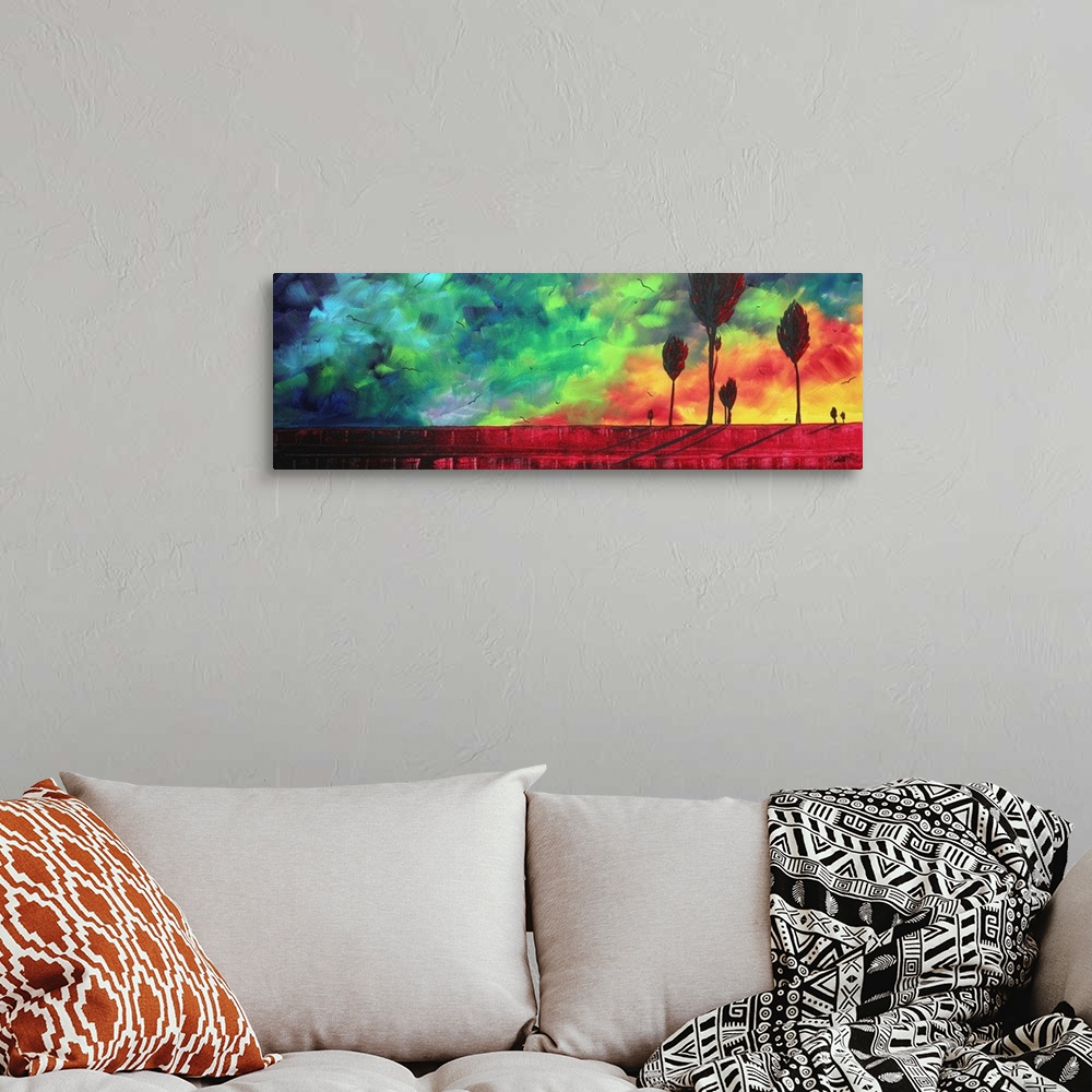 A bohemian room featuring Contemporary abstract painting of trees silhouetted against a brightly colored sky made up of bro...