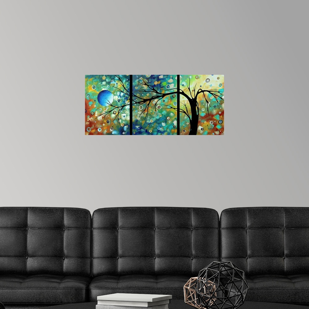 A modern room featuring Panoramic contemporary art focuses on a bare tree set against a background filled with bright and...