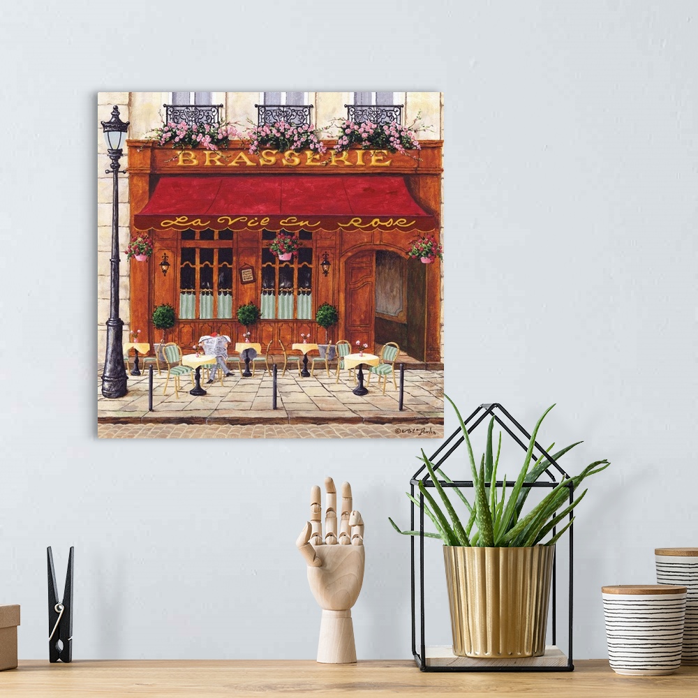 A bohemian room featuring Painting of a Parisian cafe with seating out front.