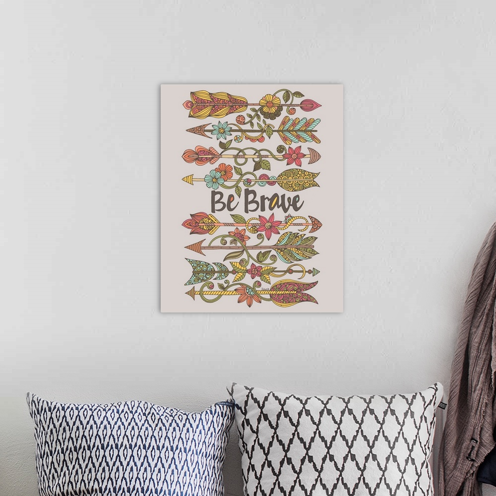 A bohemian room featuring "Be Brave" written in the center of intricately designed arrows decorated with flowers.