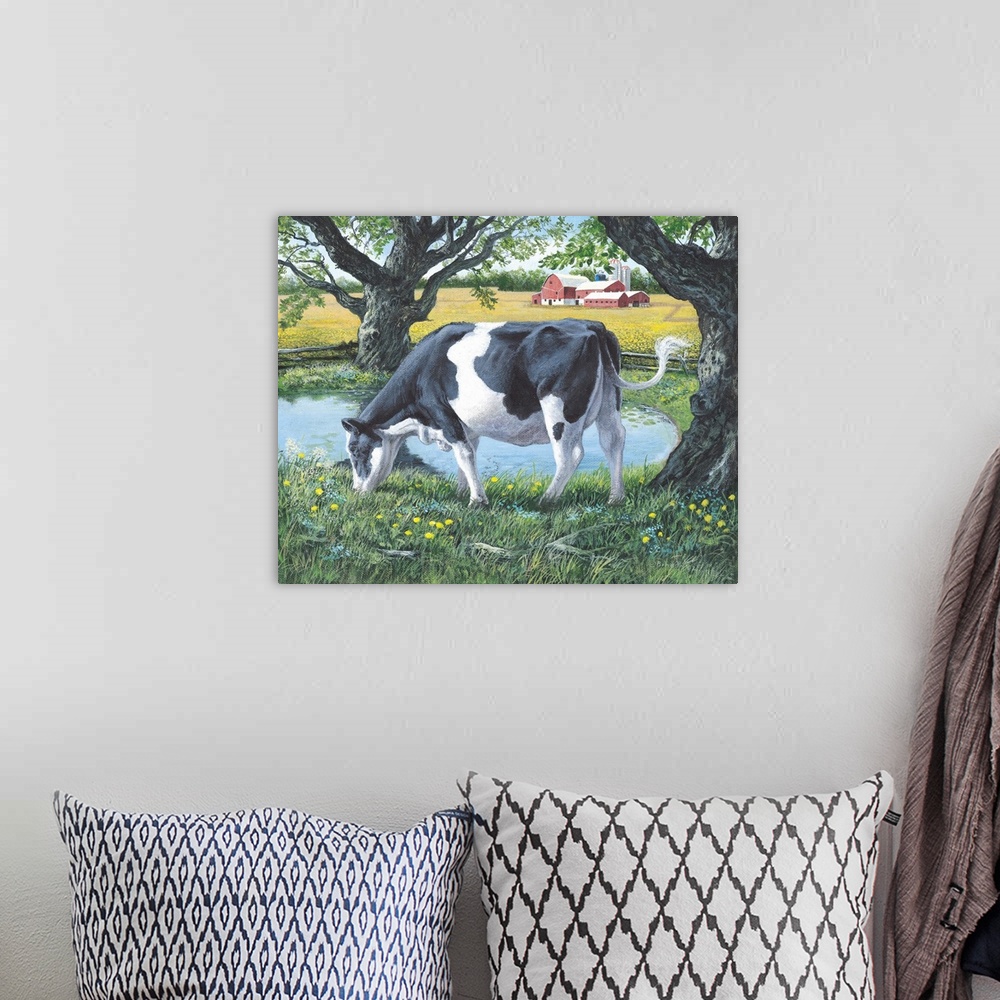 A bohemian room featuring Contemporary artwork of a cow grazing on lush grass next to a pond, with a red barn in the distance.