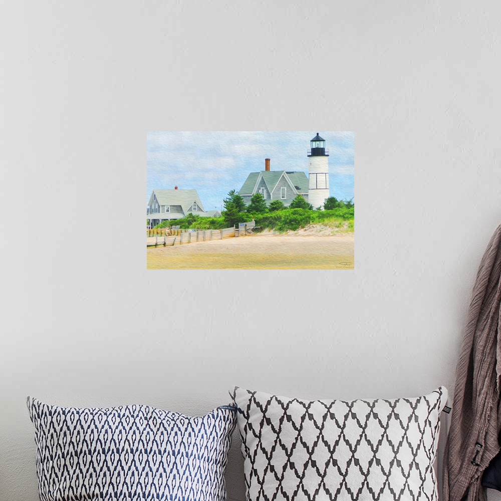 A bohemian room featuring A lighthouse on the edge of a sandy beach in New England.