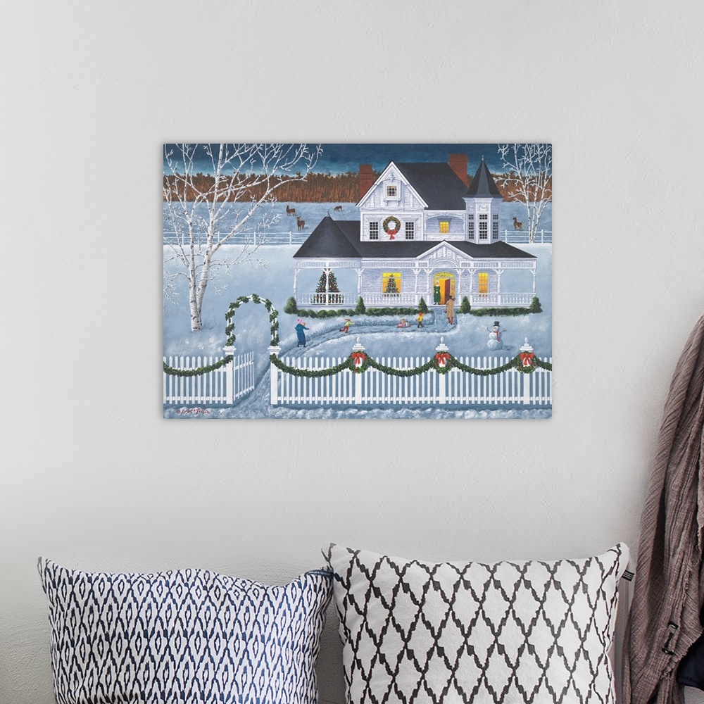 A bohemian room featuring Americana scene of a family playing in the snow outside of a house at Christmastime.