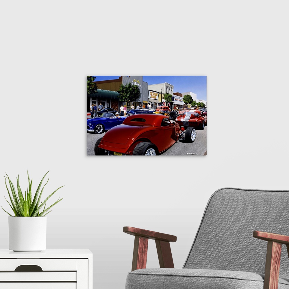 A modern room featuring Large photo print of the up close of a large group of hot rod cars driving up and down a small to...