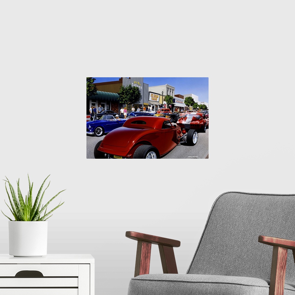 A modern room featuring Large photo print of the up close of a large group of hot rod cars driving up and down a small to...
