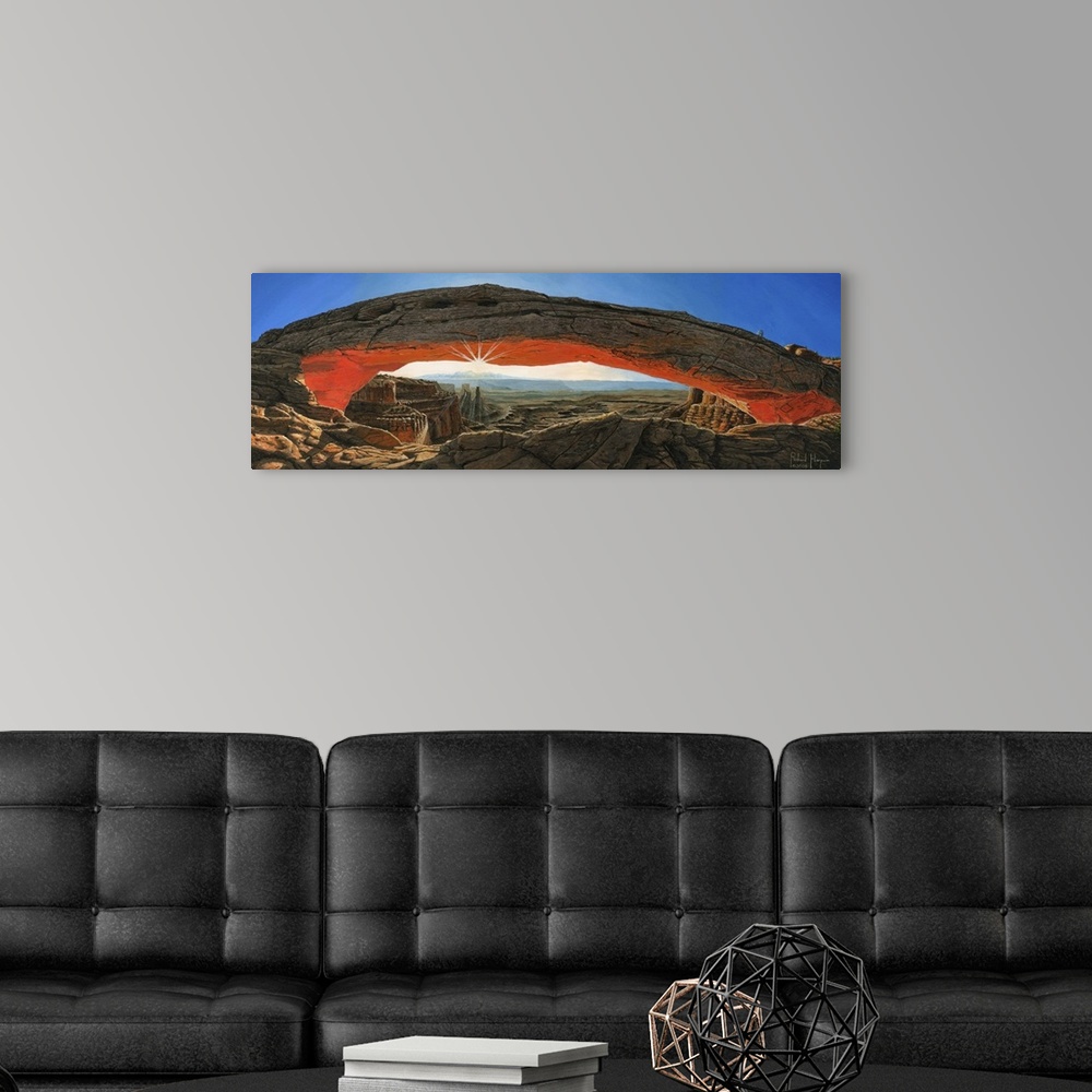 A modern room featuring Contemporary painting of a massive natural rock arch in a desert overlooking a vast rocky landscape.