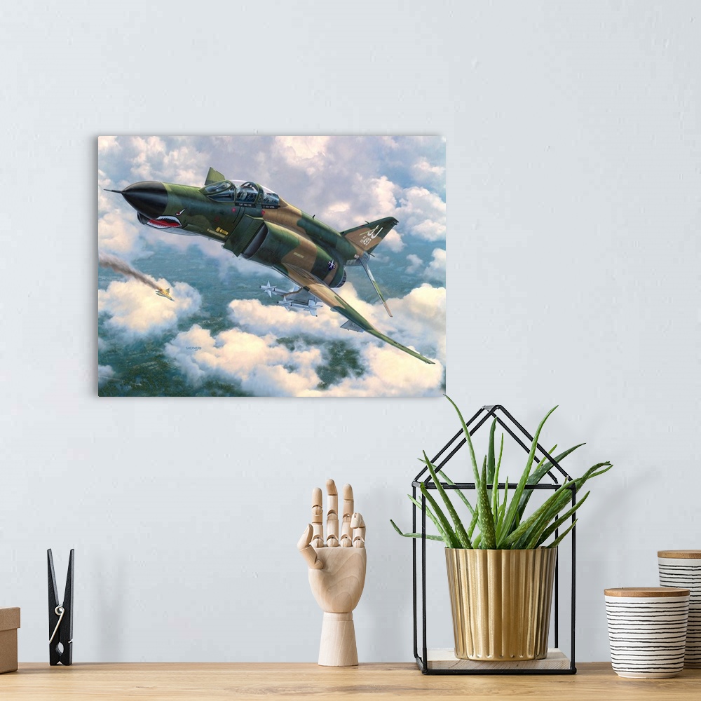 A bohemian room featuring An F-4E Phantom II flies in front of broken clouds over a tree covered jungle terrain with a Nort...