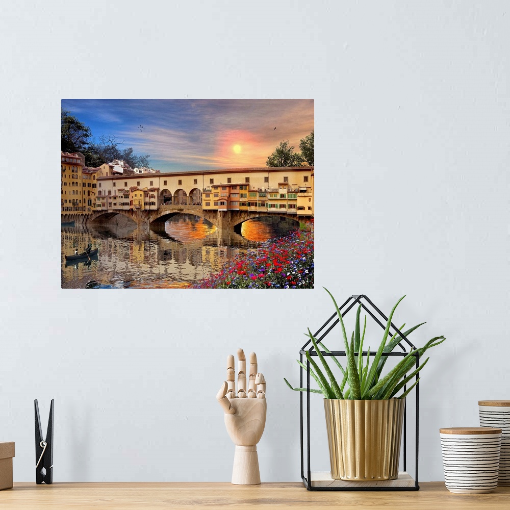 A bohemian room featuring A landscape picture of a bridge in Italy that is reflected in the water below with a canoe rowing...
