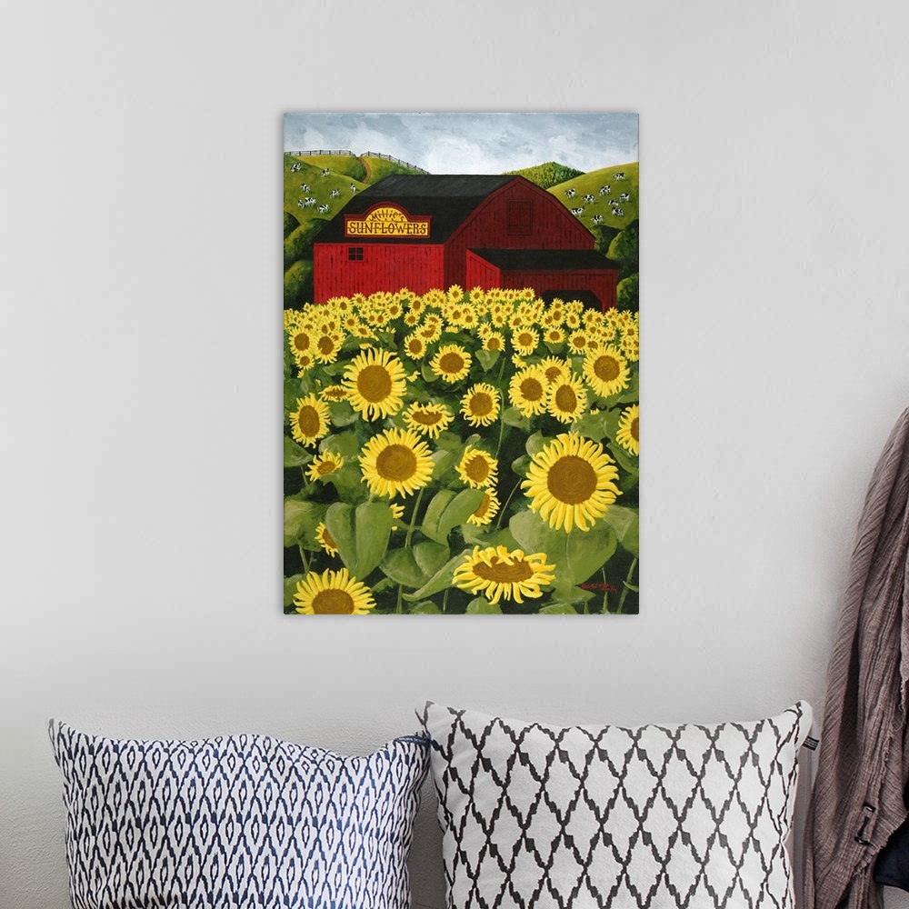A bohemian room featuring Americana scene of a big red barn in a sunflower field.