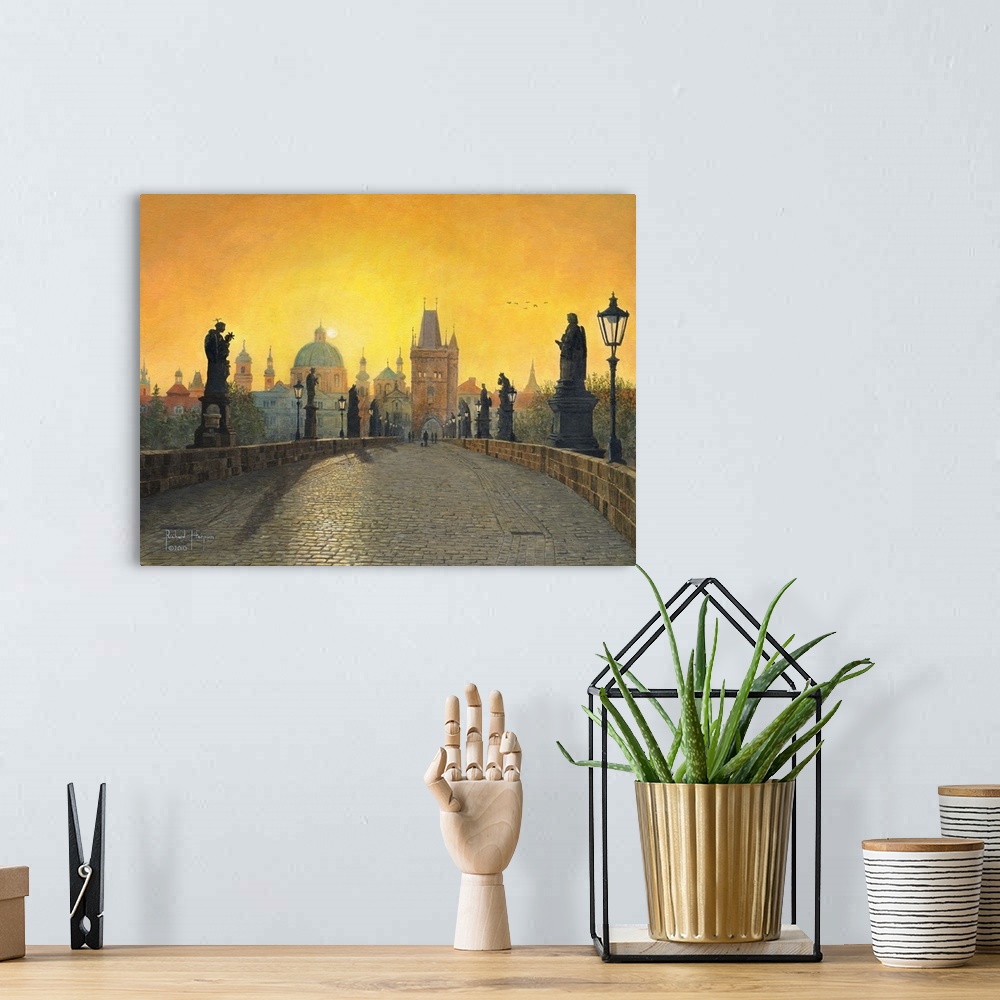 A bohemian room featuring Contemporary artwork of a view across a long old bridge lined with statues, toward a city filled ...